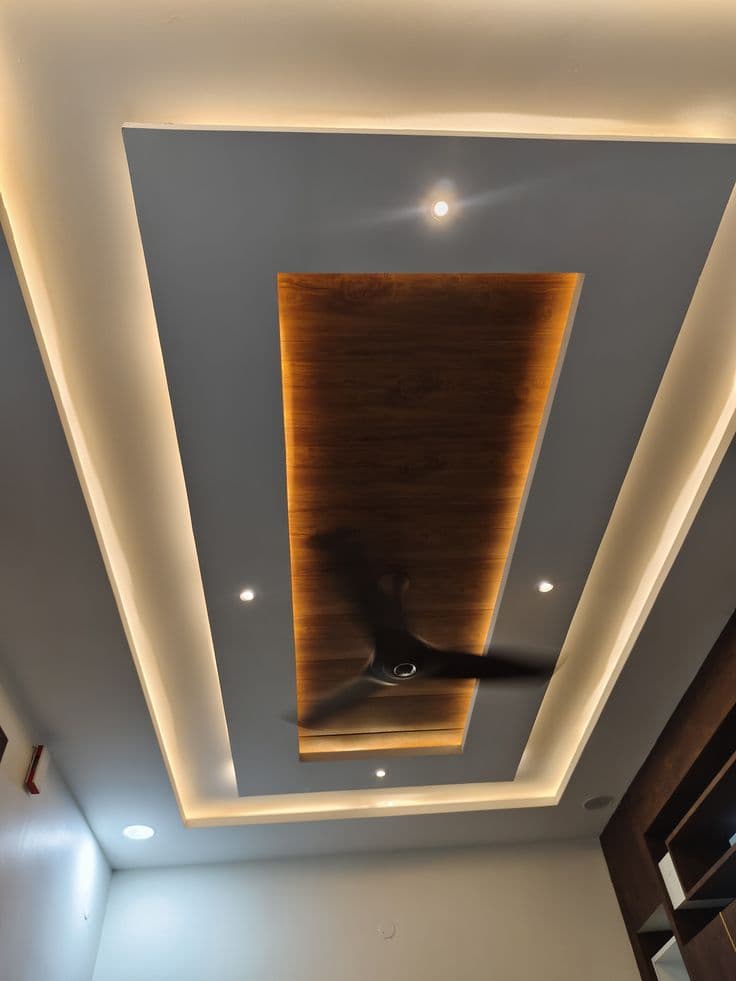 Rectangular gypsum false ceiling with wood-panel centre insert and cove lighting, Chandigarh home