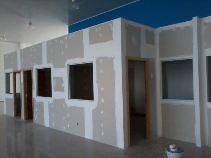 Finished gypsum partition walls with door and window openings, Chandigarh office corridor